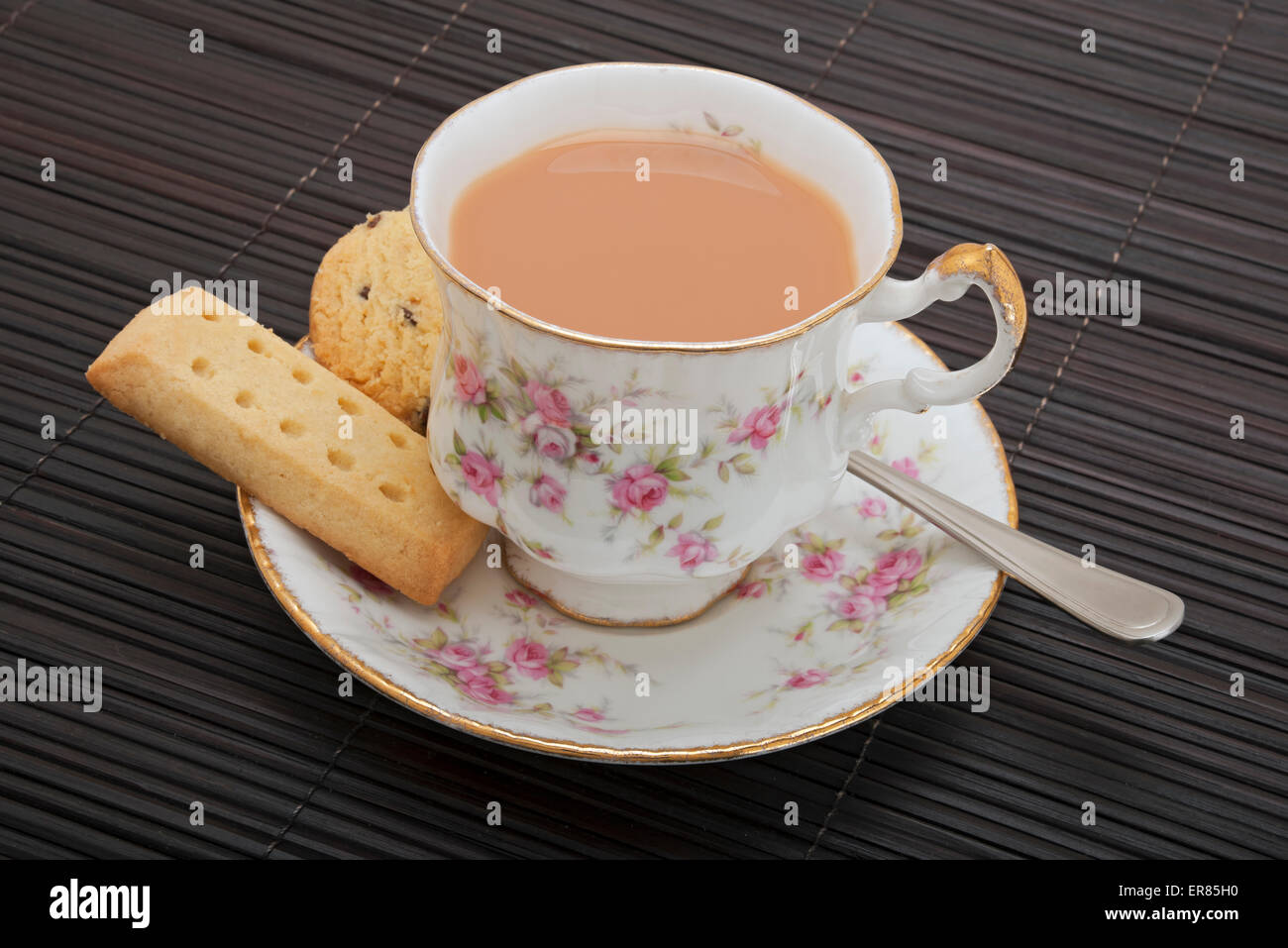 Nahaufnahme einer Tasse Tee mit Milch und Buttergebäck Stockfoto