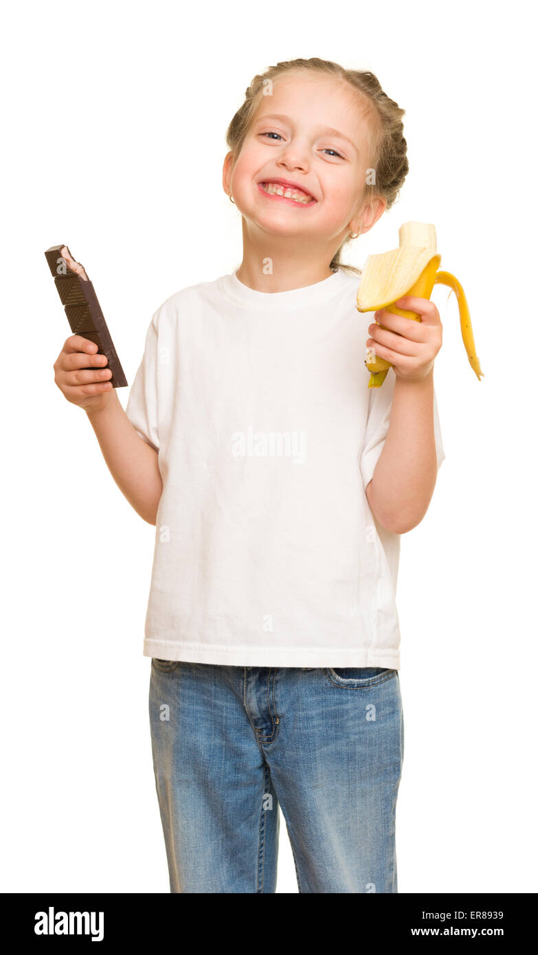 kleine Mädchen essen Bananen und Schokolade Stockfoto