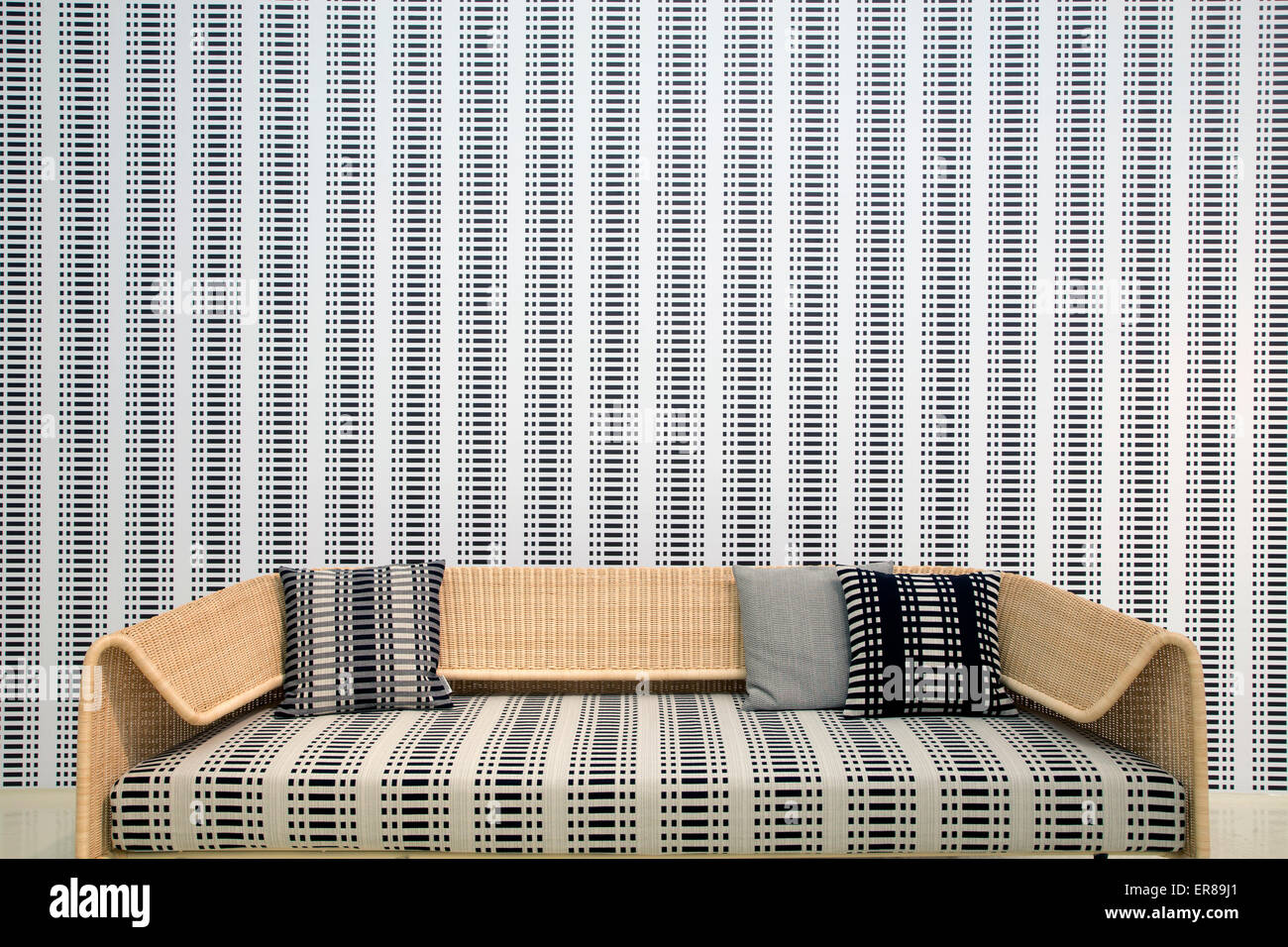 Interieur mit einem hölzernen Sessel und ein Holzsofa mit einer Tapete im Hintergrund Stockfoto