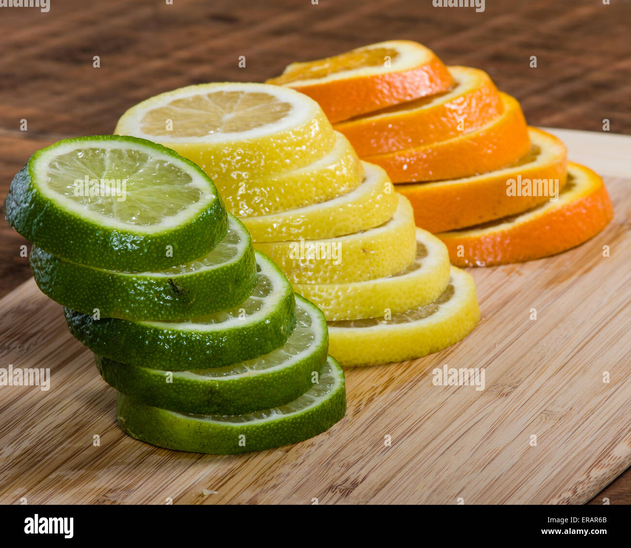 Stapel von Zitrone, Limette und Orange Scheiben auf Schneidebrett Stockfoto