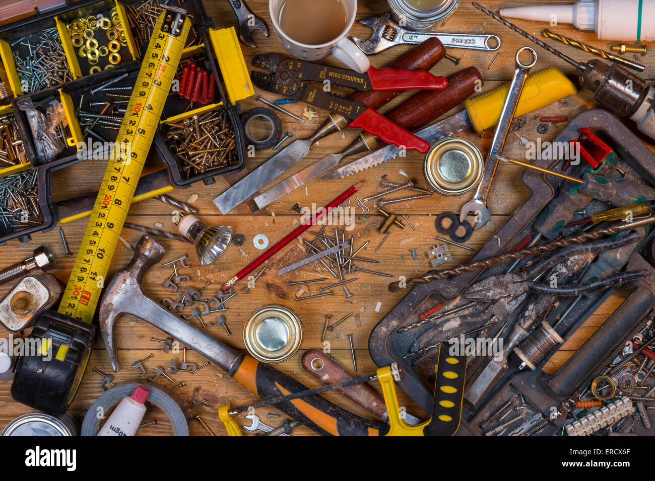 Pflege zu Hause - eine unordentliche Werkbank voller staubigen alten Werkzeuge und Schrauben. Stockfoto