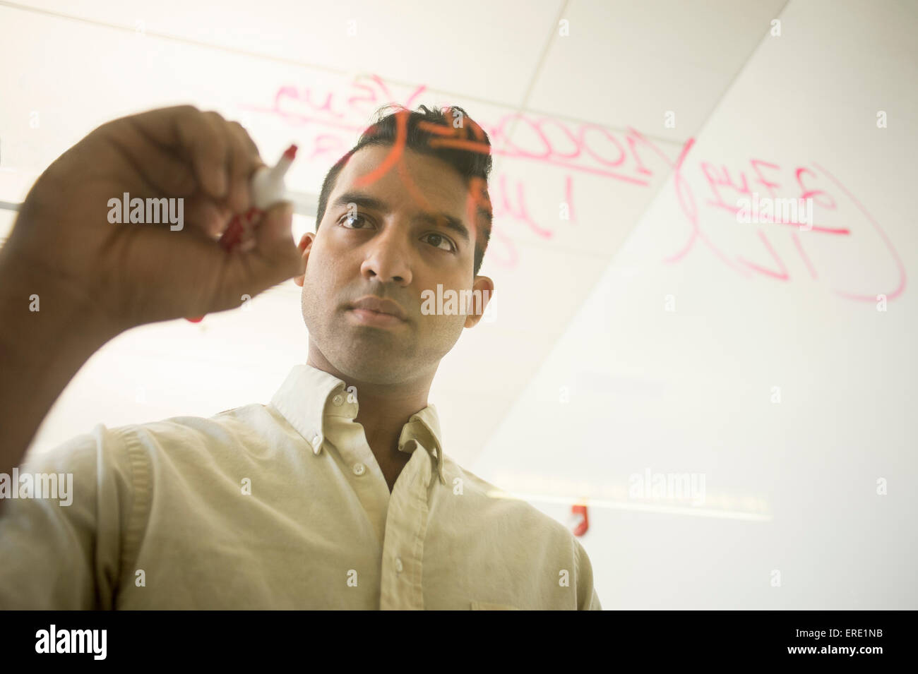 Asiatische Geschäftsmann schreiben Formeln auf Fenster Stockfoto