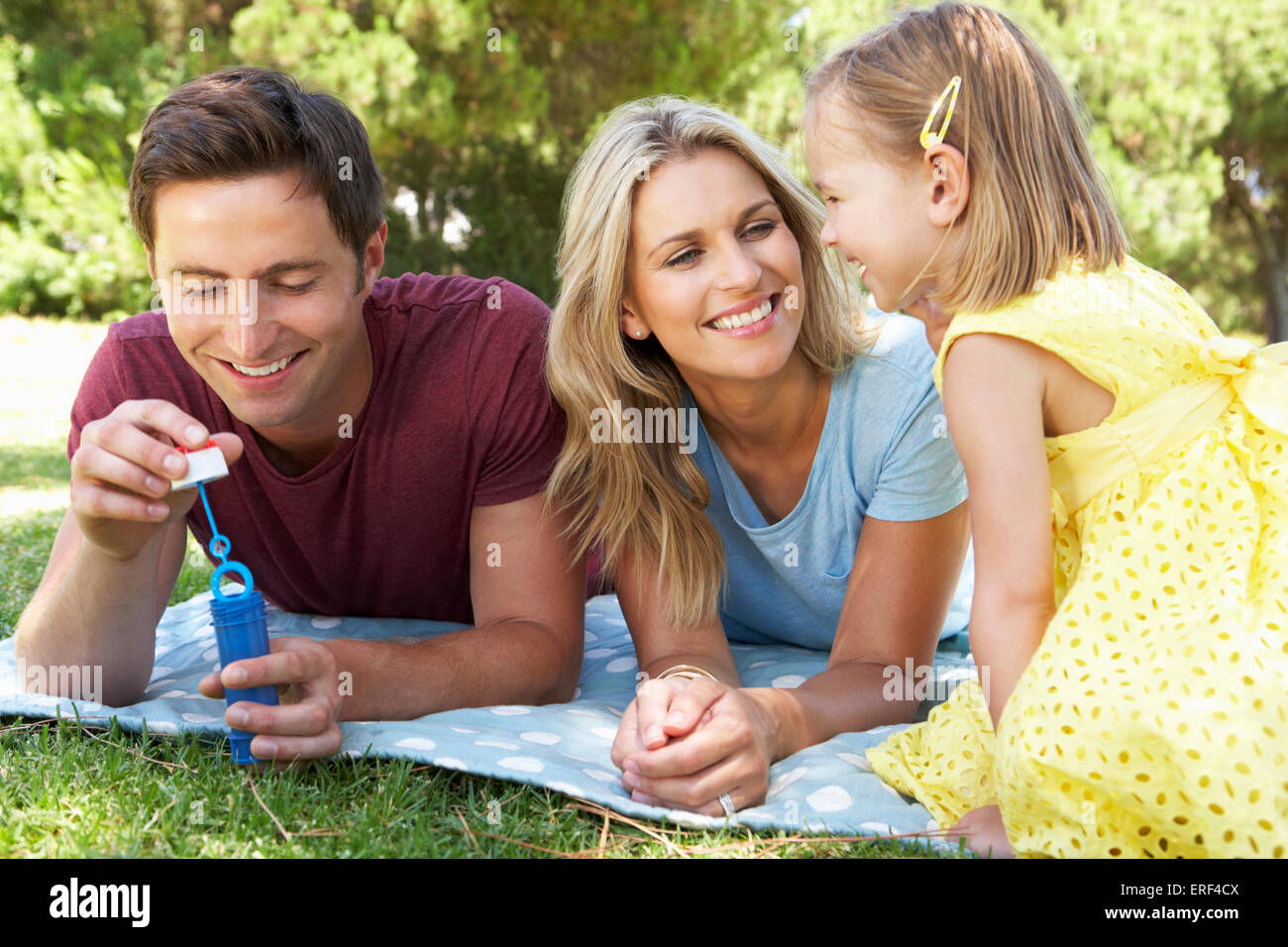 Familie im Garten spielen und Seifenblasen Stockfoto