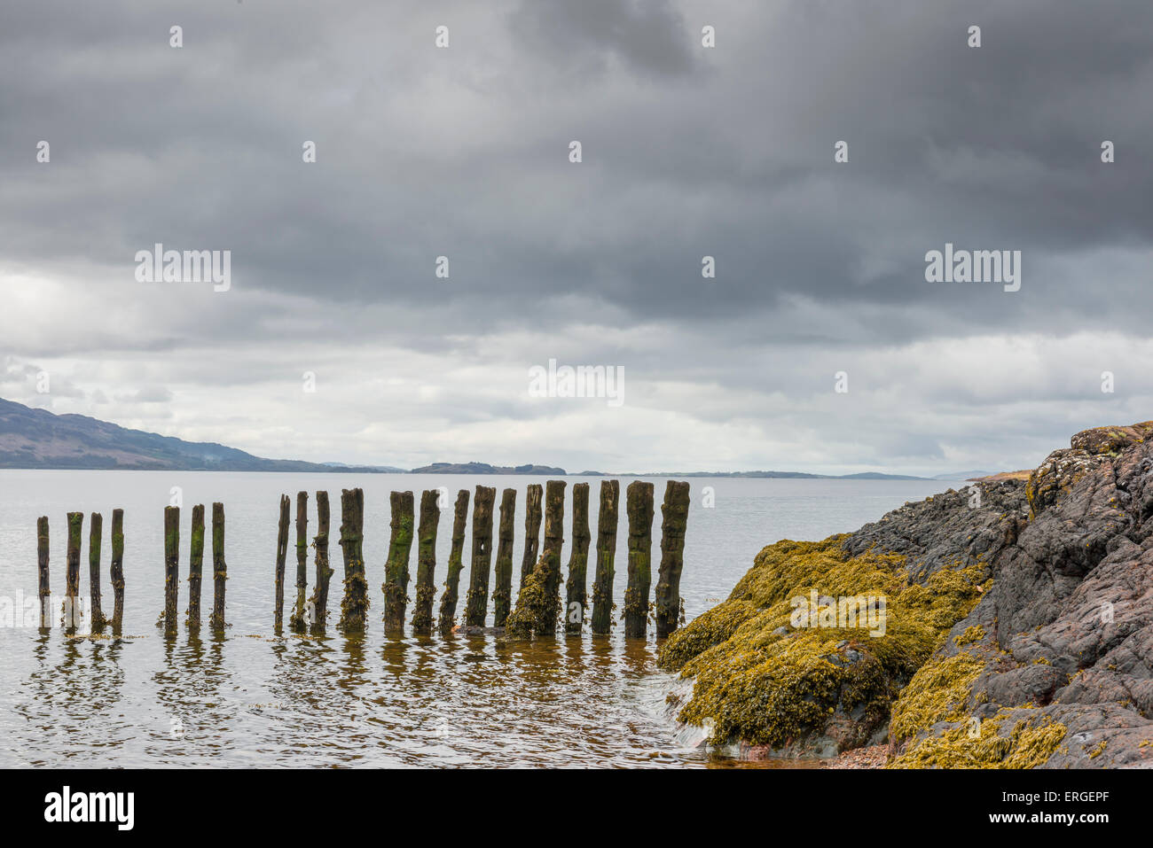 Pole an der Coatsline von Schottland mit dunklen Regenwolken am Horizont. Stockfoto