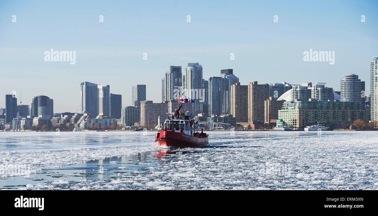 Fire Rescue Boot gegen die Skyline der Stadt vom Wards Island im Winter; Toronto, Ontario, Kanada Stockfoto