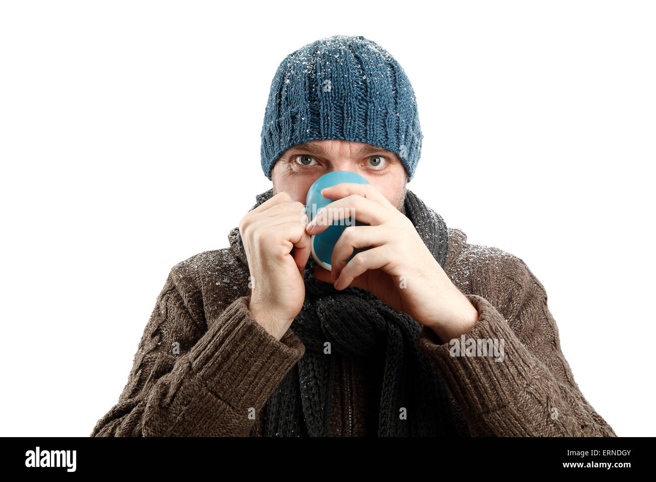Attraktiver Mann mit einer Tasse Tee in der Hand vor einem weißen Hintergrund Stockfoto