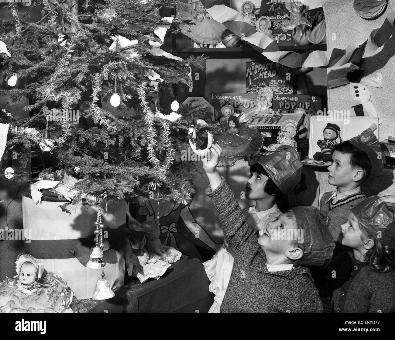 Gast bei der Weihnachtsfeier von Liverpool Child Welfare Association in deren Hauptquartier Copperas Hill, Liverpool gegeben. Wo eine 100 am meisten Bedürftigen der Stadt waren die Kinder unterhalten. George Crowder im Alter von 4, die hier zu sehen, für eines der Geschenke hangin erreichen Stockfoto