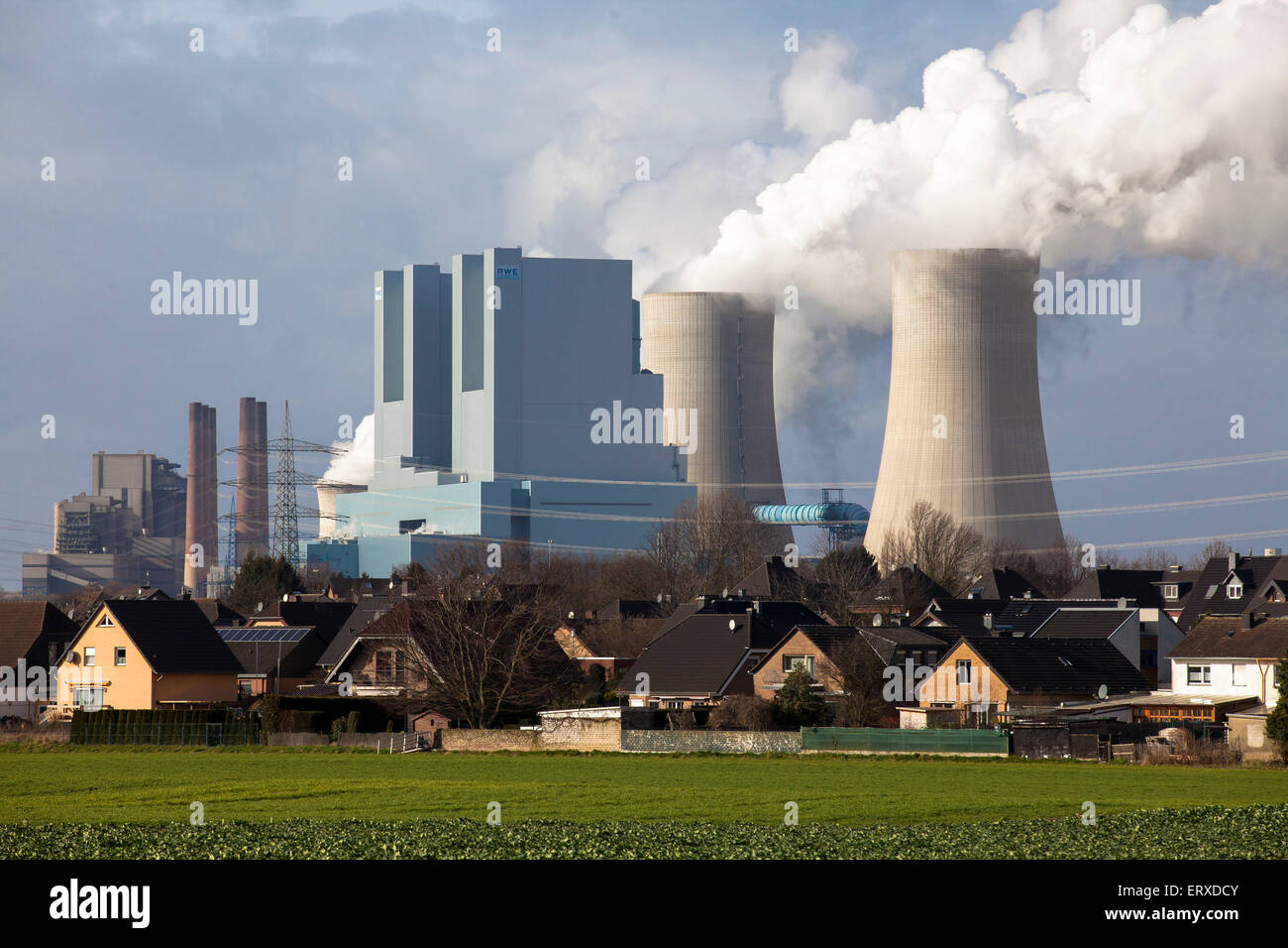 Die braunkohlegefeuerten Kraftwerk Neurath bei Grevenbroich, Deutschland, im Vordergrund Häuser in Rommerskirchen-Vanikum. Stockfoto