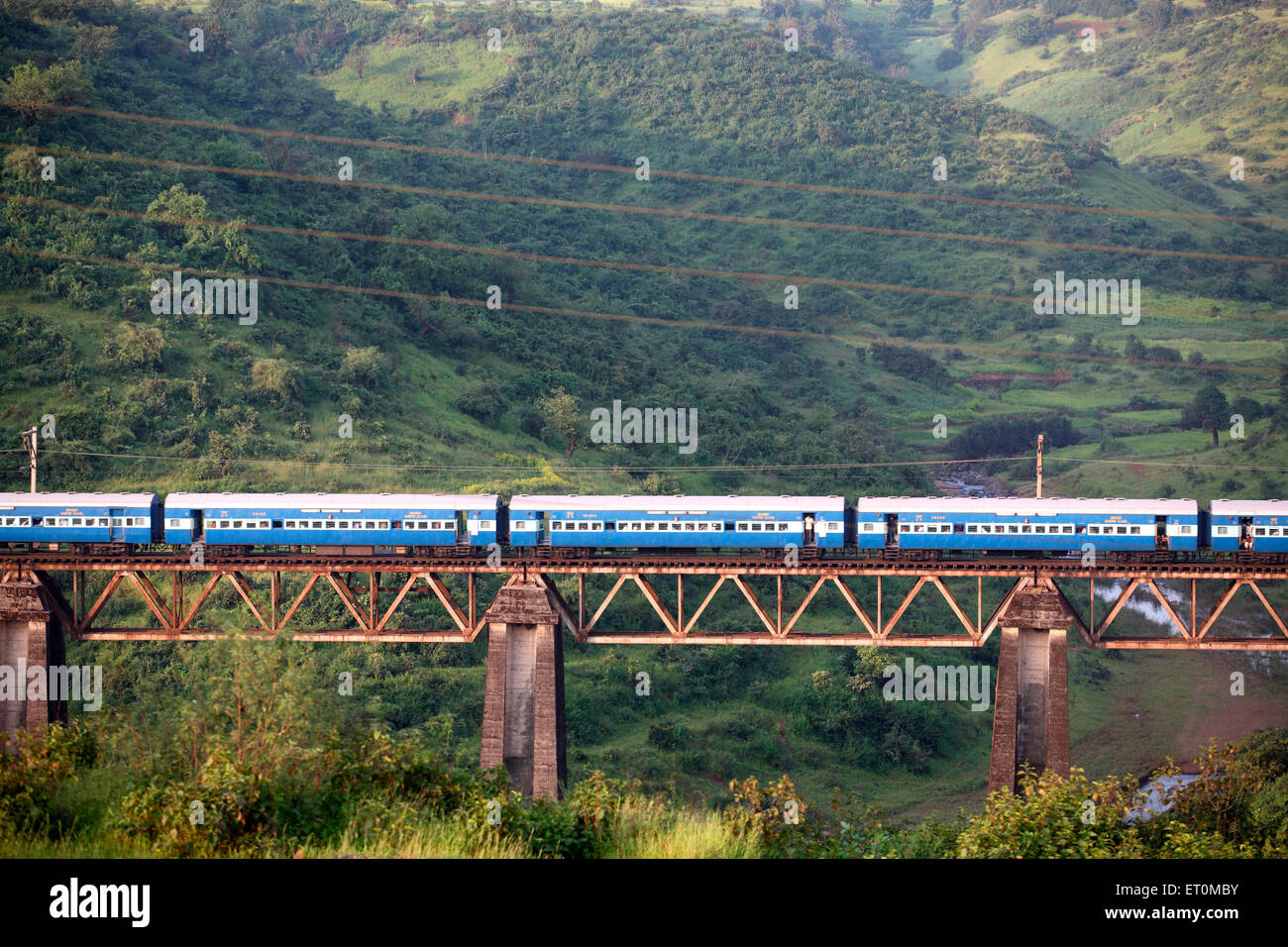 Indian Railways Zug vorbei erhöhte Brücke in Igatpuri nahe Nasik im Maharashtra; Indien Stockfoto