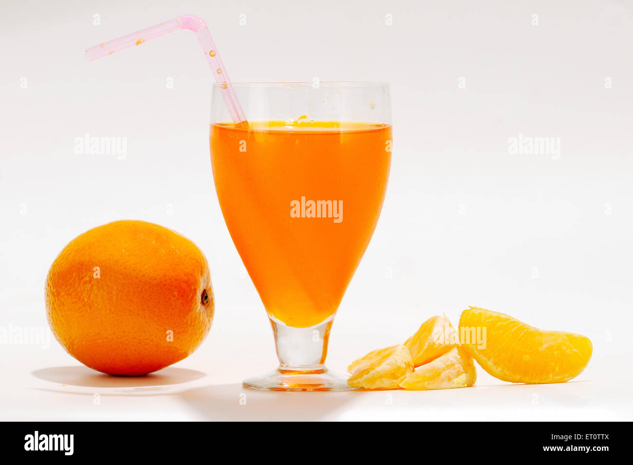 Orange mit Orangensaft in Glas auf weißem Hintergrund Stockfoto