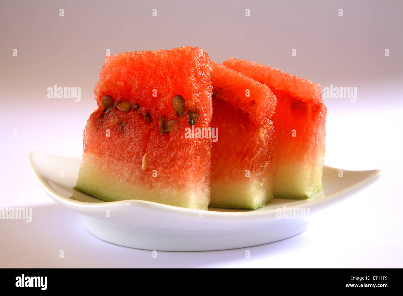 Wassermelonenscheiben in weißer Keramikschale auf weißem Hintergrund Stockfoto