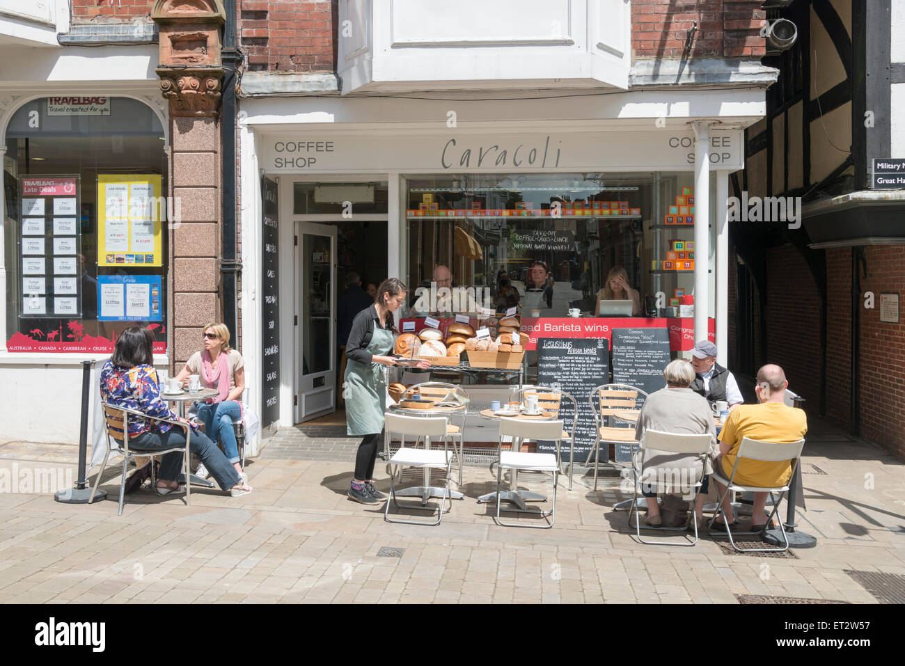 Das Caracoli Café und Coffee-Shop in der Innenstadt von Winchester UK mit Menschen Essen und trinken an Tischen auf dem Bürgersteig Stockfoto