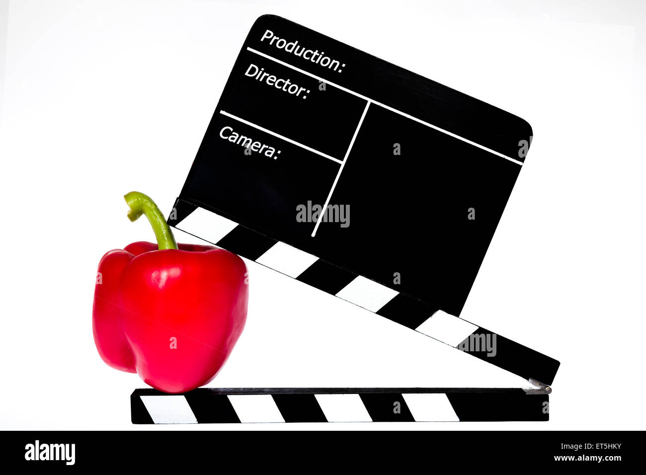 Paprika und Film Klappe - weißer Hintergrund Stockfoto