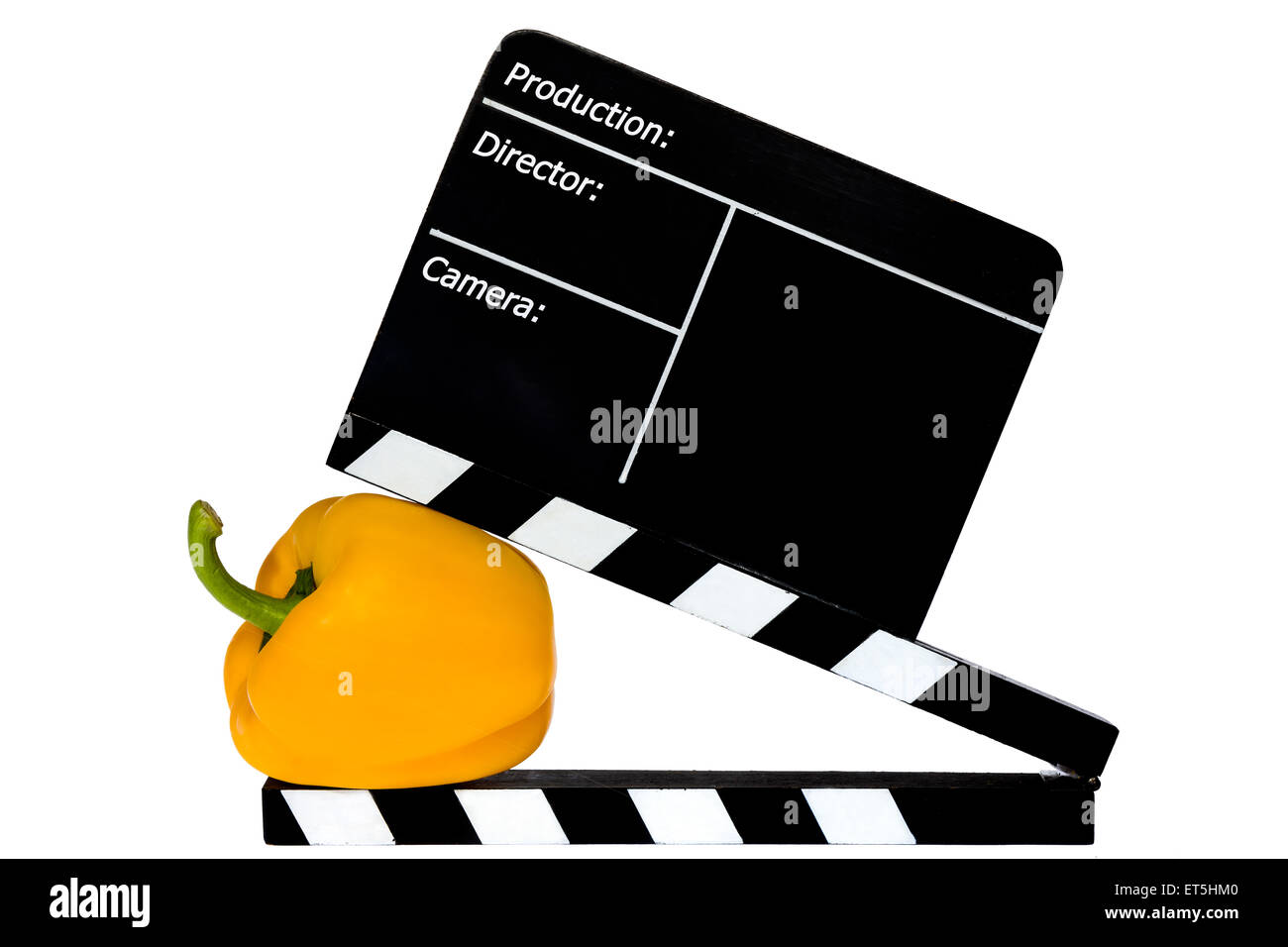 Gelbe Paprika und Film Klappe - weißer Hintergrund Stockfoto