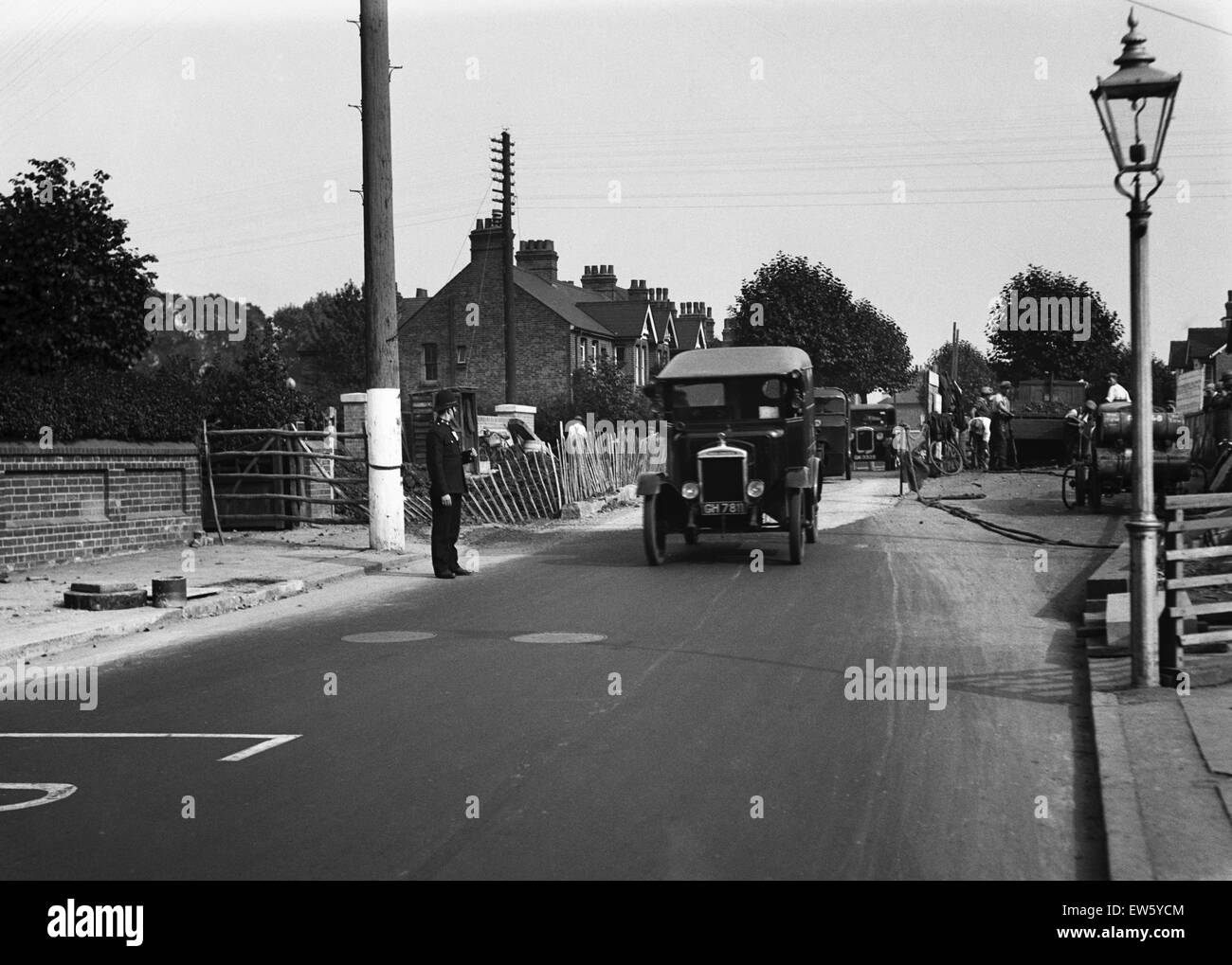 Polizei direkte Zugriffe, wie Arbeiter der Straße an einem unbekannten Ort in Uxbridge, London zu reparieren. Ca. 1931 Stockfoto