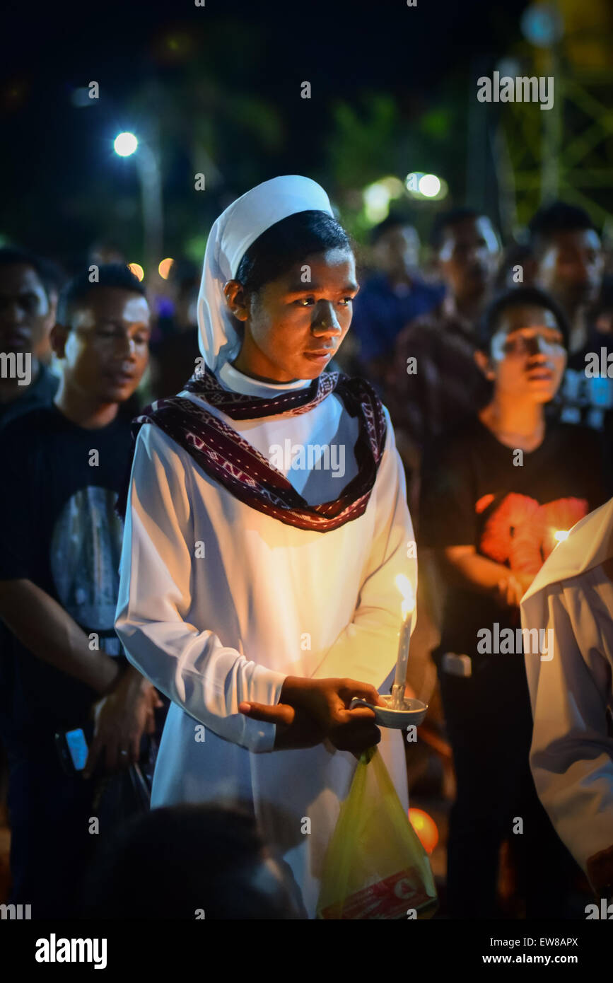 Nonne hält Kerze, wie sie mit anderen Gläubigen in einer Prozession der Semana Santa in Larantuka, Insel Flores, Indonesien marschiert. Stockfoto