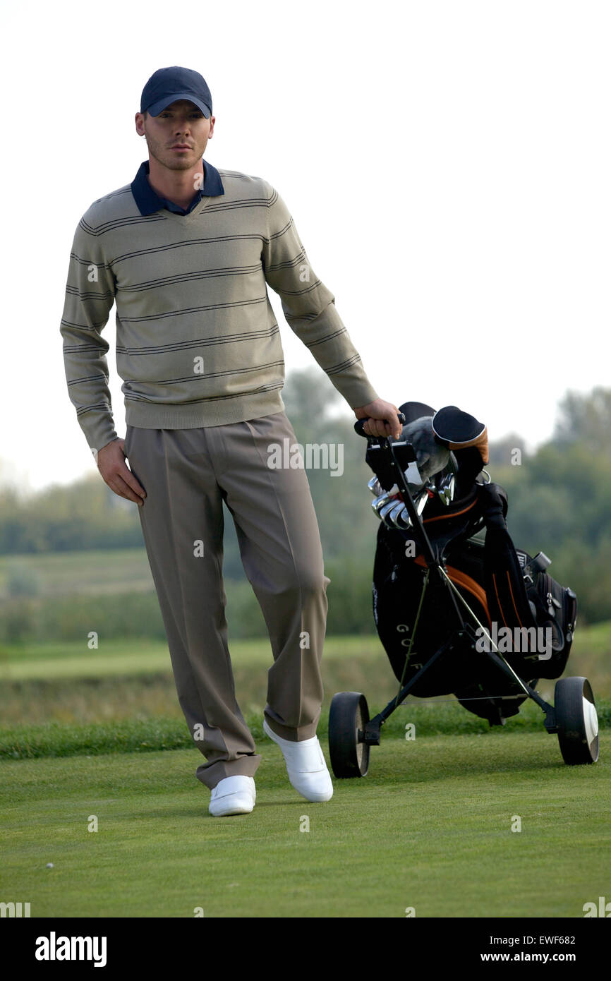Porträt des jungen Mannes tragen Trolley mit Golf-bag Stockfotografie -  Alamy