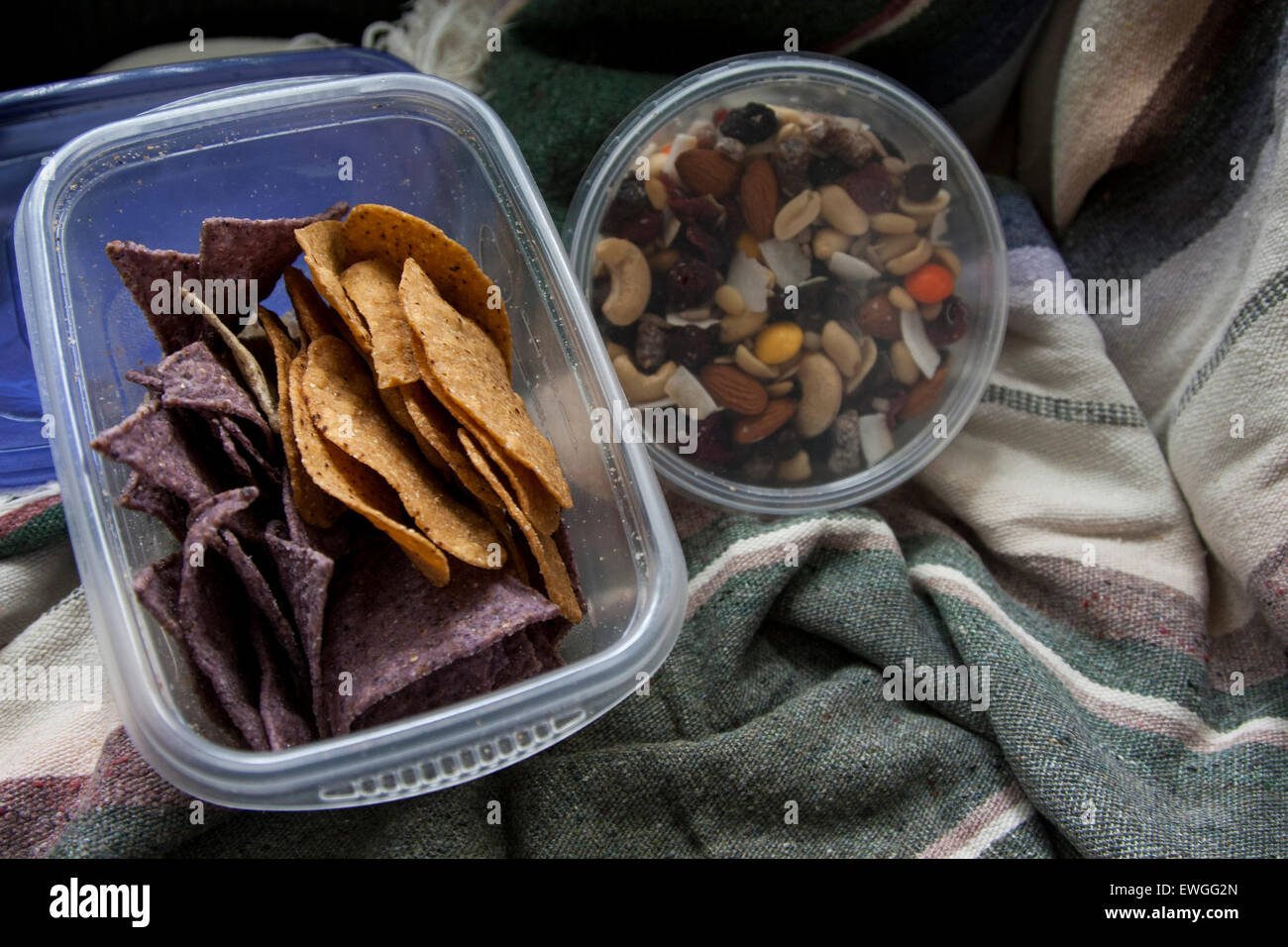 Snacks für Auto camping - blauen Mais-Tortilla-Chips, süße Kartoffel-Tortilla-Chips und Trail mix. Stockfoto