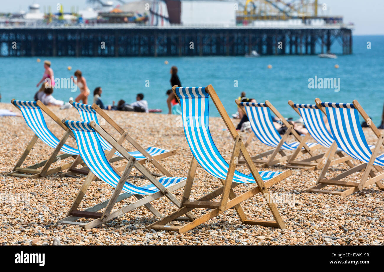 Traditionelle Old-fashioned blau-weiß gestreiften Liegestühlen am Strand vor dem Palace Pier, Brighton, East Sussex, UK Stockfoto