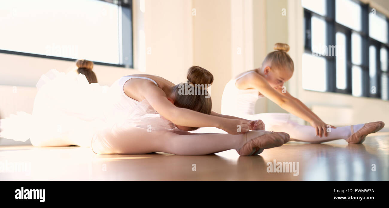 Kleines Ballett Mädchen machen ein Stretching Warm Up Übung in the Studio bevor ihre Tanz-Praxis. Stockfoto