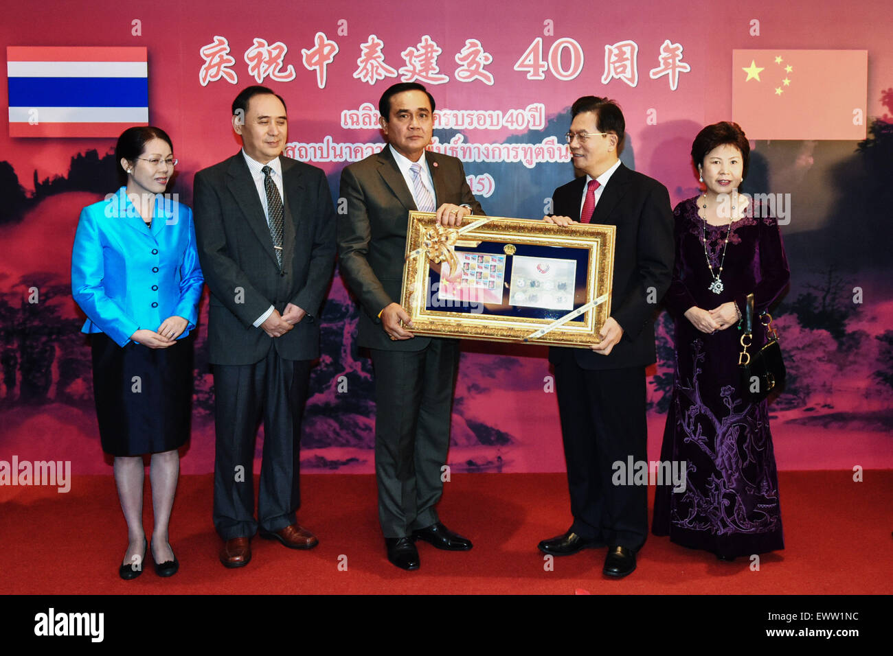 Bangkok, Thailand. 1. Juli 2015. Thai Prime Minister Prayuth Chan-OCHA (C) stellt eine Reihe von commemorative Briefmarken, chinesischer Botschafter in Thailand Ning Fukui (2. R) im Rahmen eines Empfangs durch die chinesische Botschaft in Thailand anlässlich der 40. Jahrestag der diplomatischen Beziehungen der Sino-Thai in Bangkok, Thailand, 1. Juli 2015 statt. © Li Mangmang/Xinhua/Alamy Live-Nachrichten Stockfoto