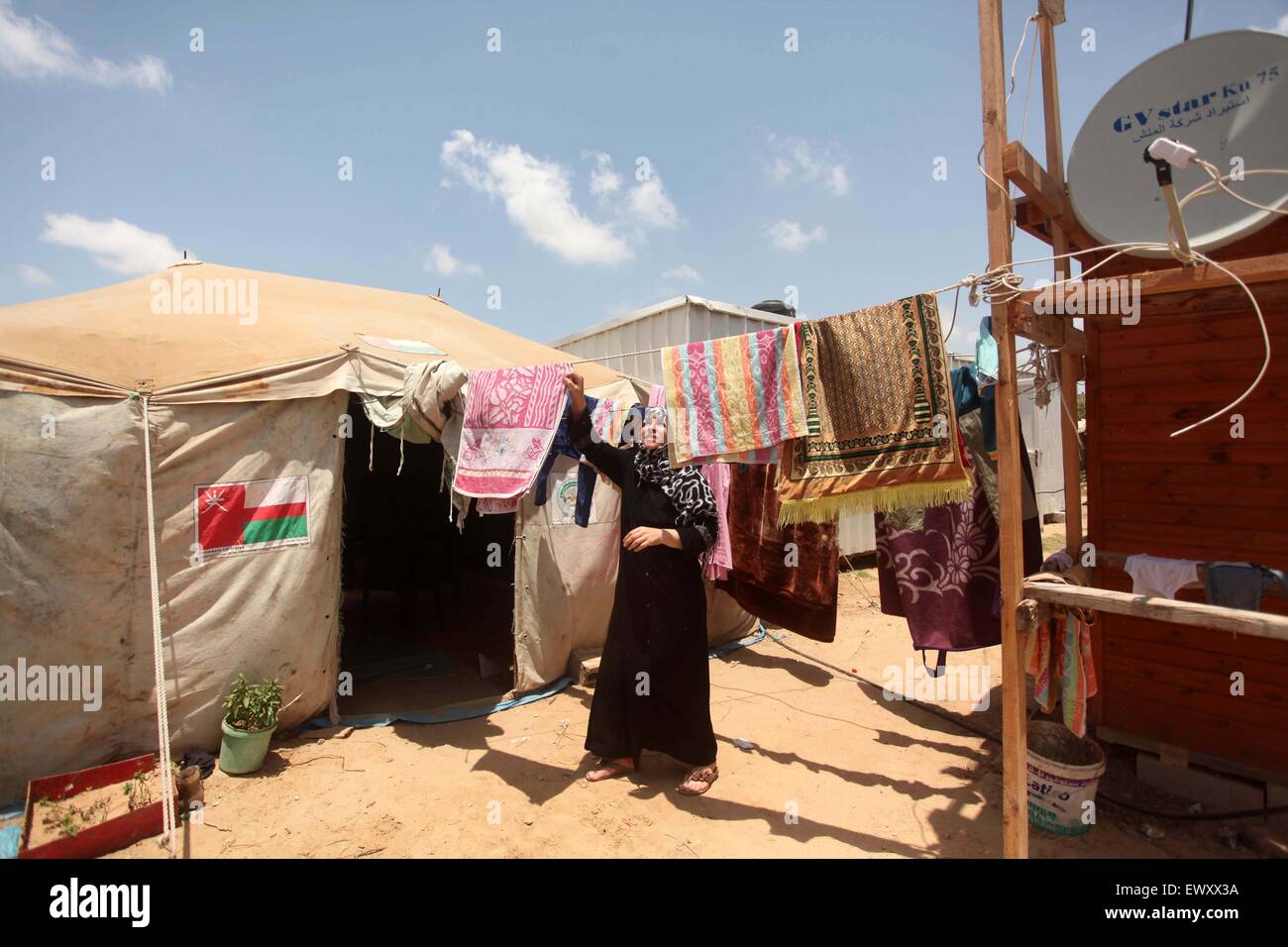 Khan Younis, Gazastreifen, Palästinensische Gebiete. 2. Juli 2015. Eine Palästinenserin sammelt Wäscherei in der Nähe der Ruinen von ihrem Haus, die Zeugen sagten durch israelischen Beschuss in einem 50-Tage-Krieg letzten Sommer in Khan Younis im südlichen Gazastreifen 2. Juli 2015 zerstört wurde. Robert Turner hat keine schnelle und einfache Antwort gefragt, um die schlimmsten Zeiten in seinen drei Jahren laufenden Hilfsmaßnahmen der Vereinten Nationen in Gaza Credit zu nennen: Ashraf Amra/APA Bilder/ZUMA Draht/Alamy Live News Stockfoto