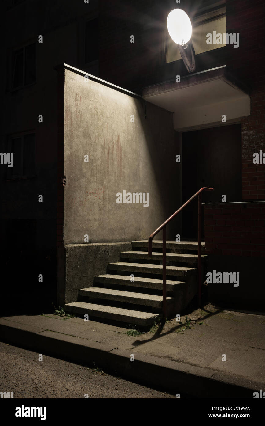 Städtischen Hintergrund. Wand und Treppen unter der Lampe Licht in der Nacht. Stockfoto
