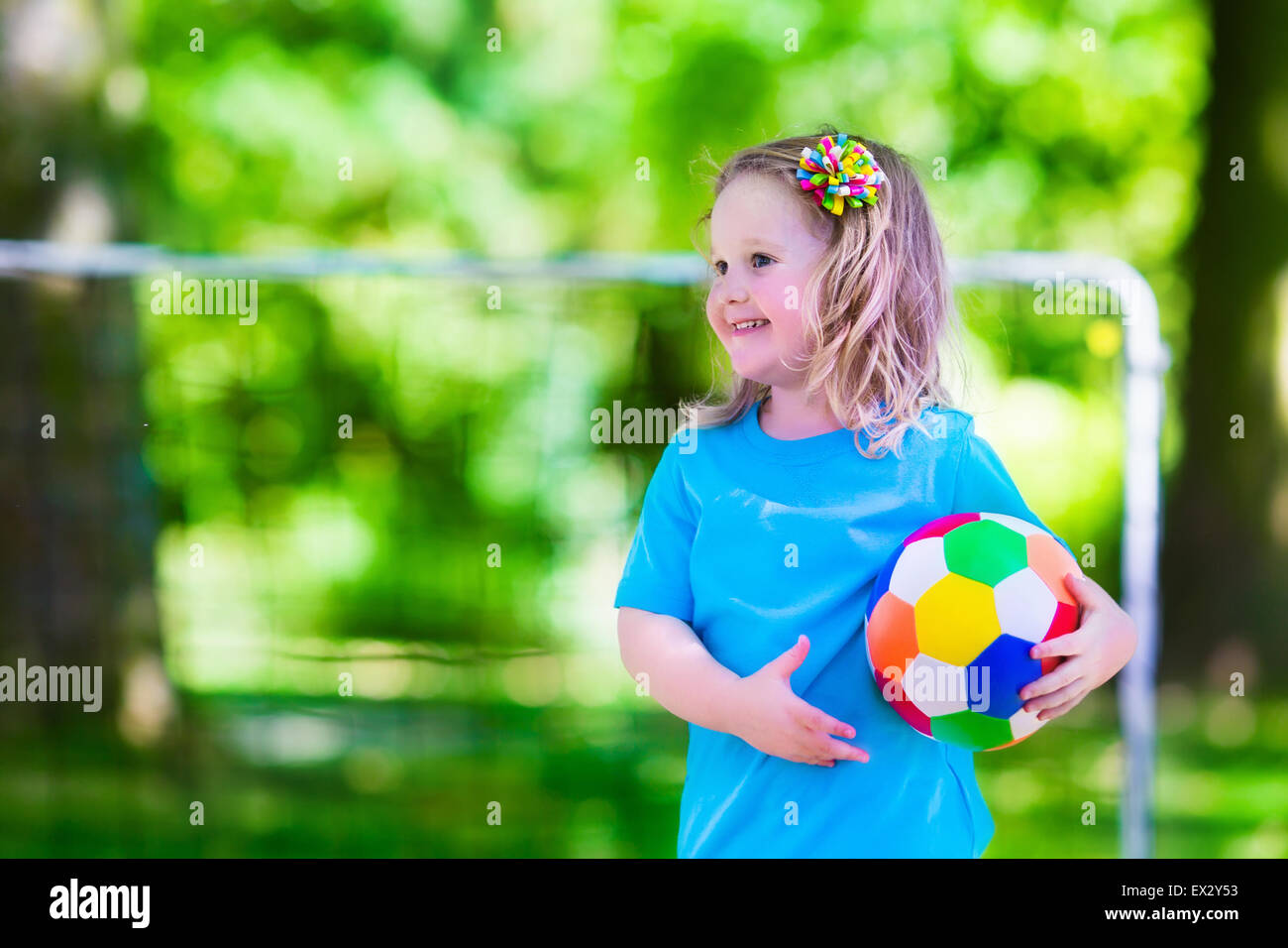 Zwei glückliche Kinder spielen Fußball im Freien im Schulhof. Kinder spielen Fußball. Aktiv Sport für Vorschulkind. Stockfoto