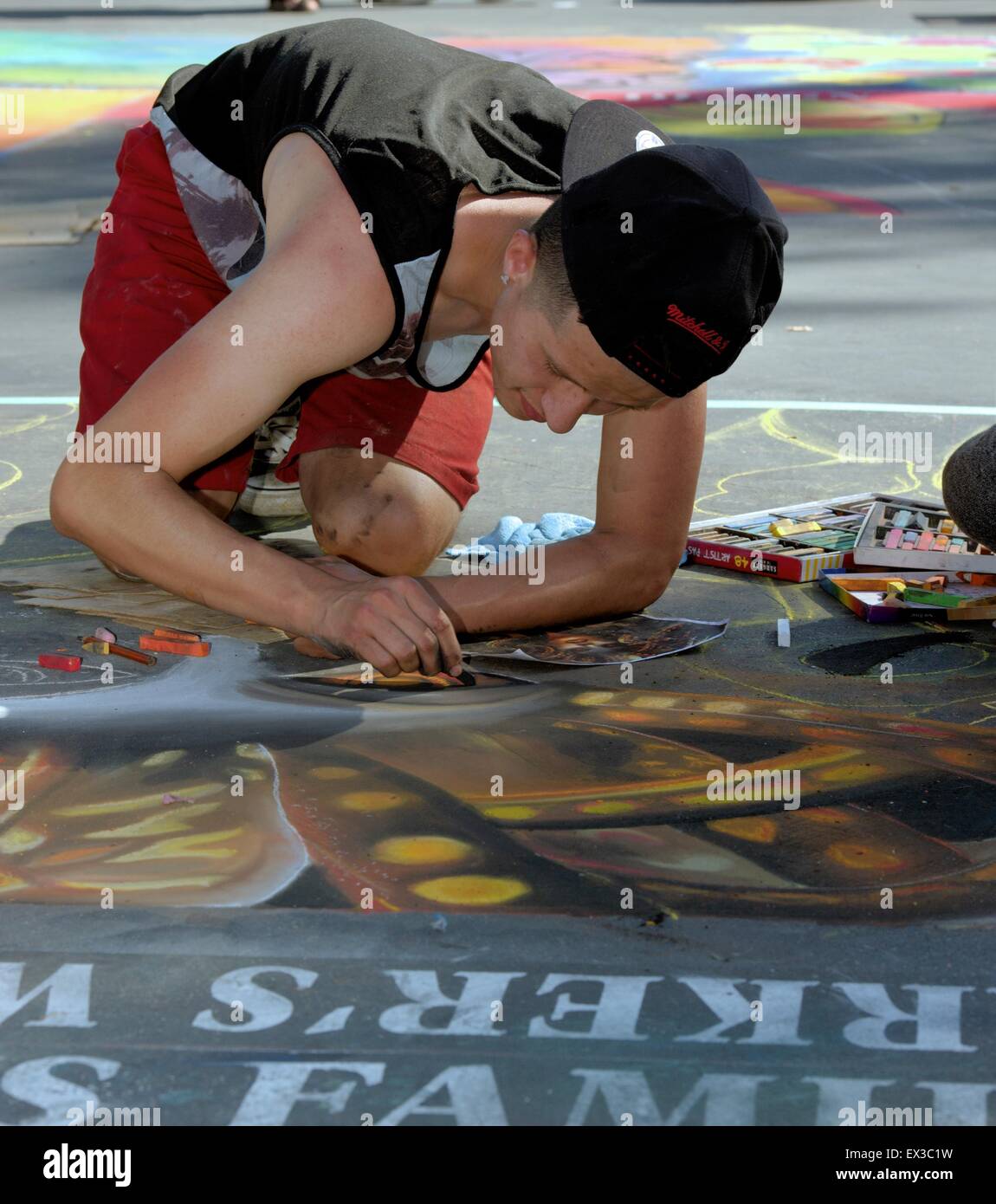 Ein junger Mann-Künstler malen mit Kreide an der "alten Santa Barbara Mission" während der ich-Madonnari, street Painting festival Stockfoto