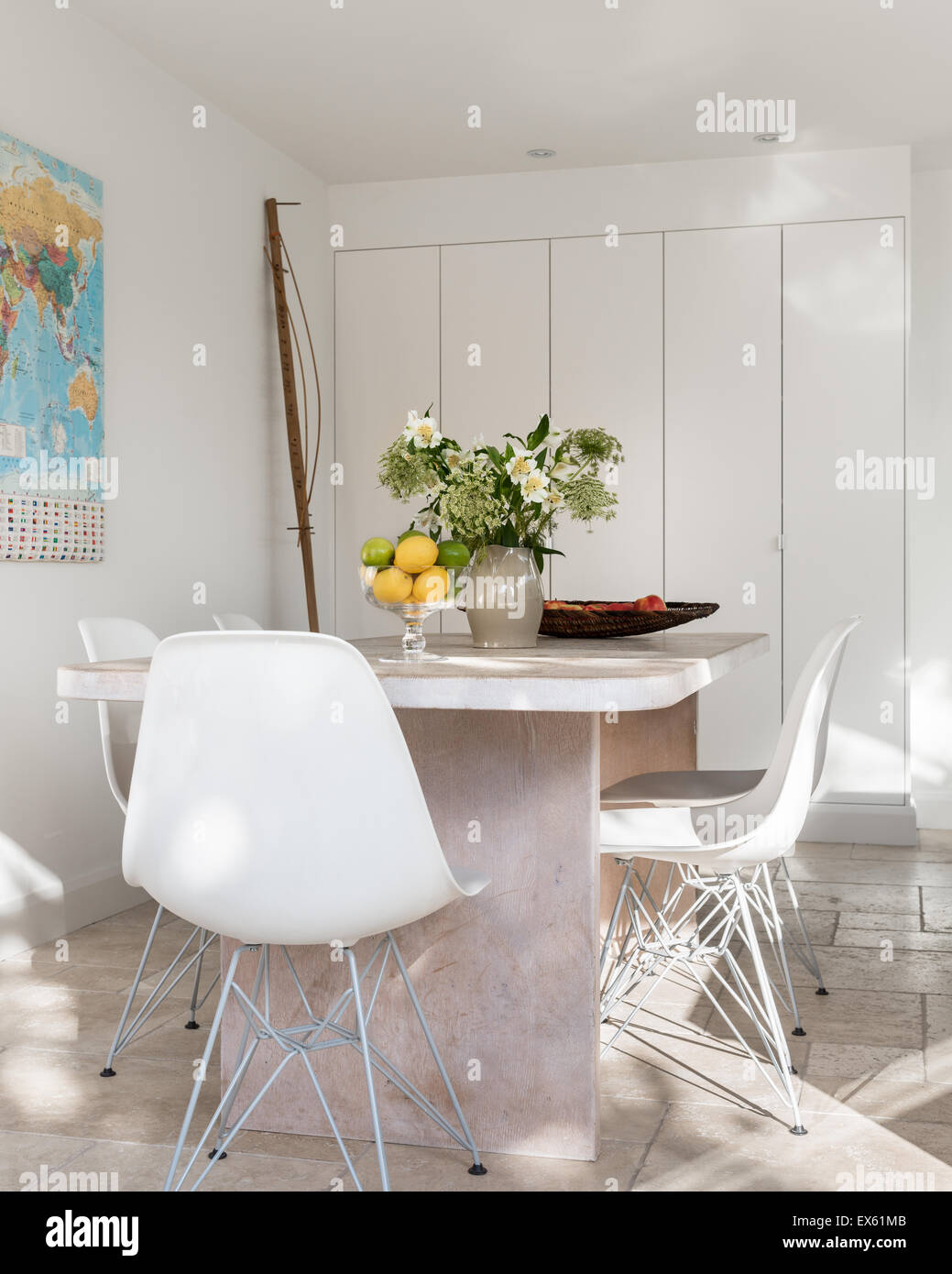 Weiße Kunststoff Eames Stühle um benutzerdefinierte gemacht Tisch von Kalk und gewachster Eiche Stockfoto