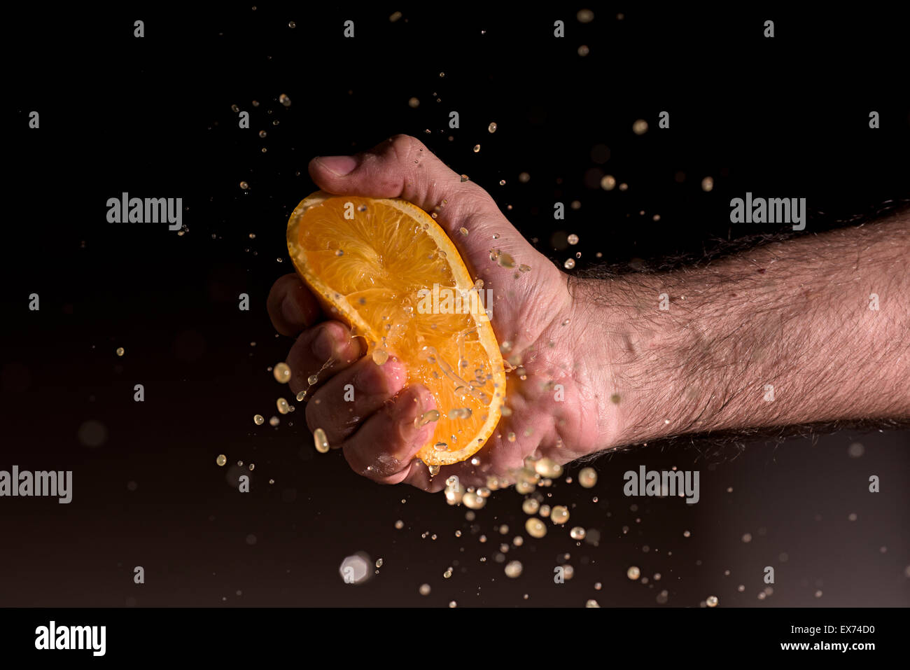 Männliche Hand drückte eine orange Stockfoto