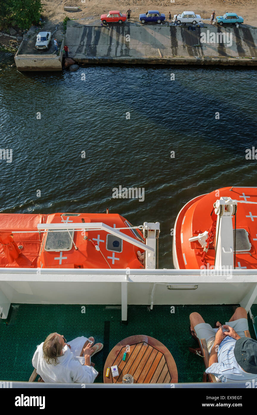 Kreuzfahrt-Passagiere beobachten Männer waschen ihre Autos Lada Riva am Stadtrand von St. Petersburg. Russland Stockfoto