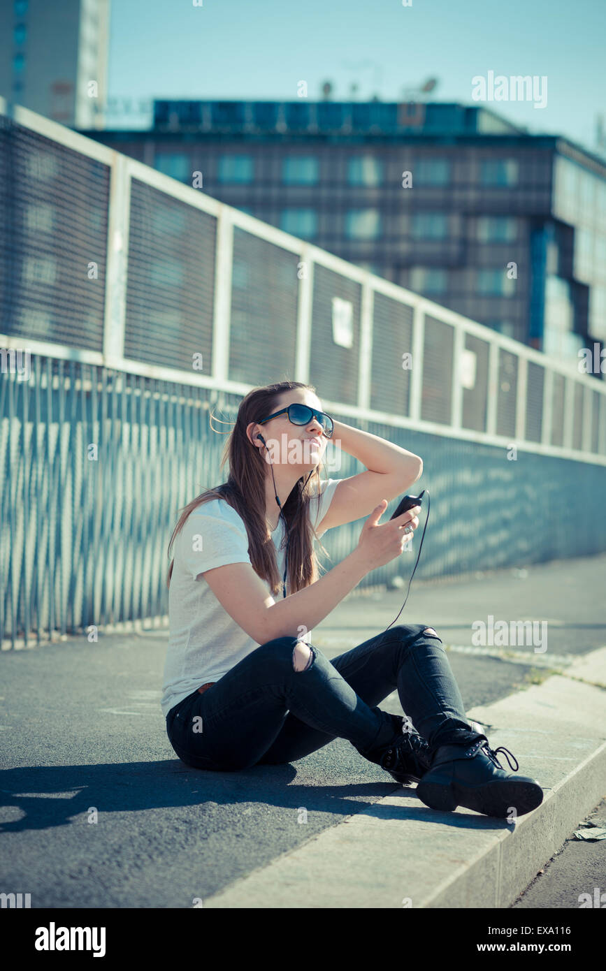 junge schöne Frau Musik hören in der Stadt Stockfoto
