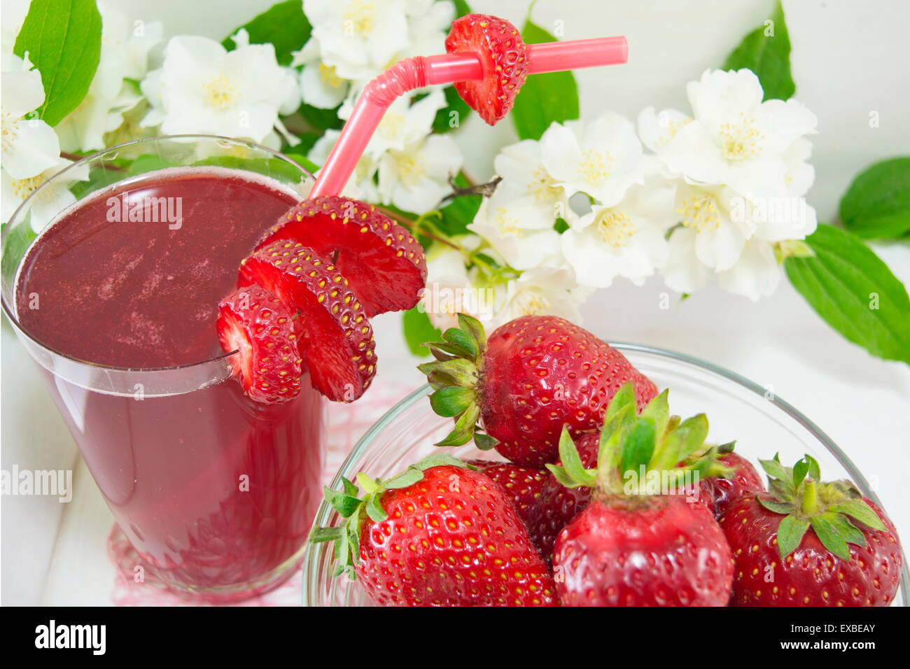 Erdbeersaft und frischen Erdbeeren serviert auf die Blumen dekorierten Teller Stockfoto
