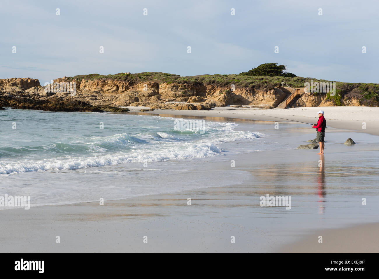 Fischer am Strand mit Angelrute. Stockfoto