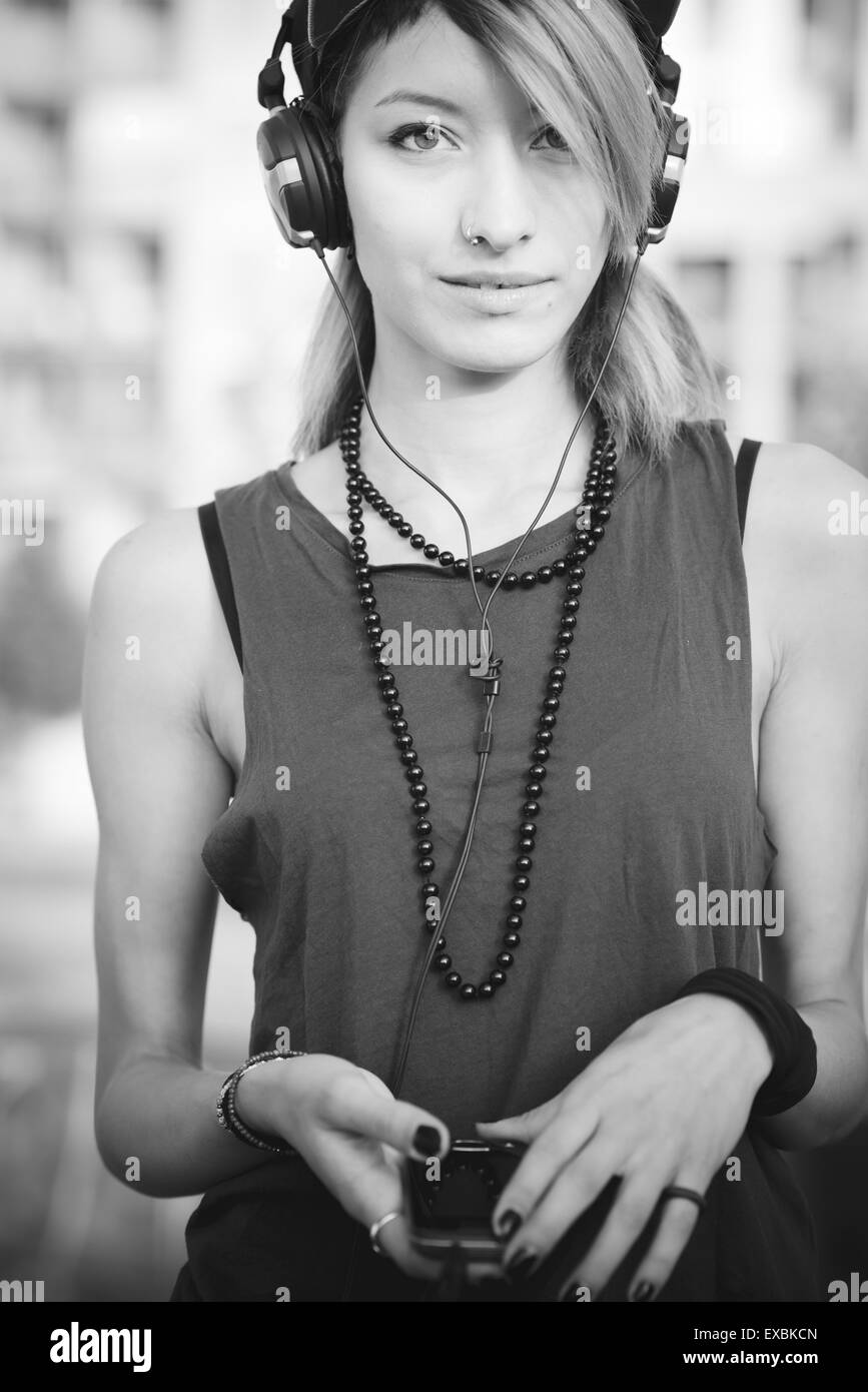 junge schöne Modell Frau Musik hören in der Stadt Stockfoto