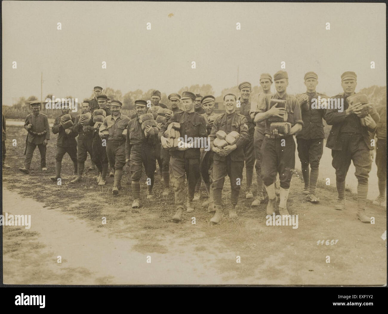 Dieses Foto zeigt amerikanische Kriegsgefangene, die während des Ersten Weltkriegs ihr tägliches Brot erhalten, das in einem deutschen Kriegsgefangenenlager gefangen genommen wurde, und spiegelt die schwierigen Bedingungen wider, denen Soldaten während des Krieges ausgesetzt waren, sowie die Grundversorgung der Gefangenen. Stockfoto