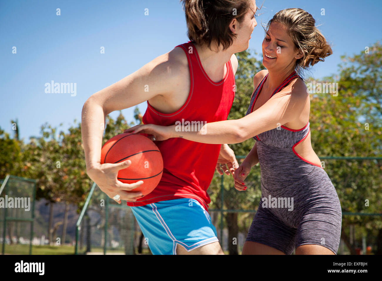 Junges Paar flirten am Basketballplatz Stockfoto