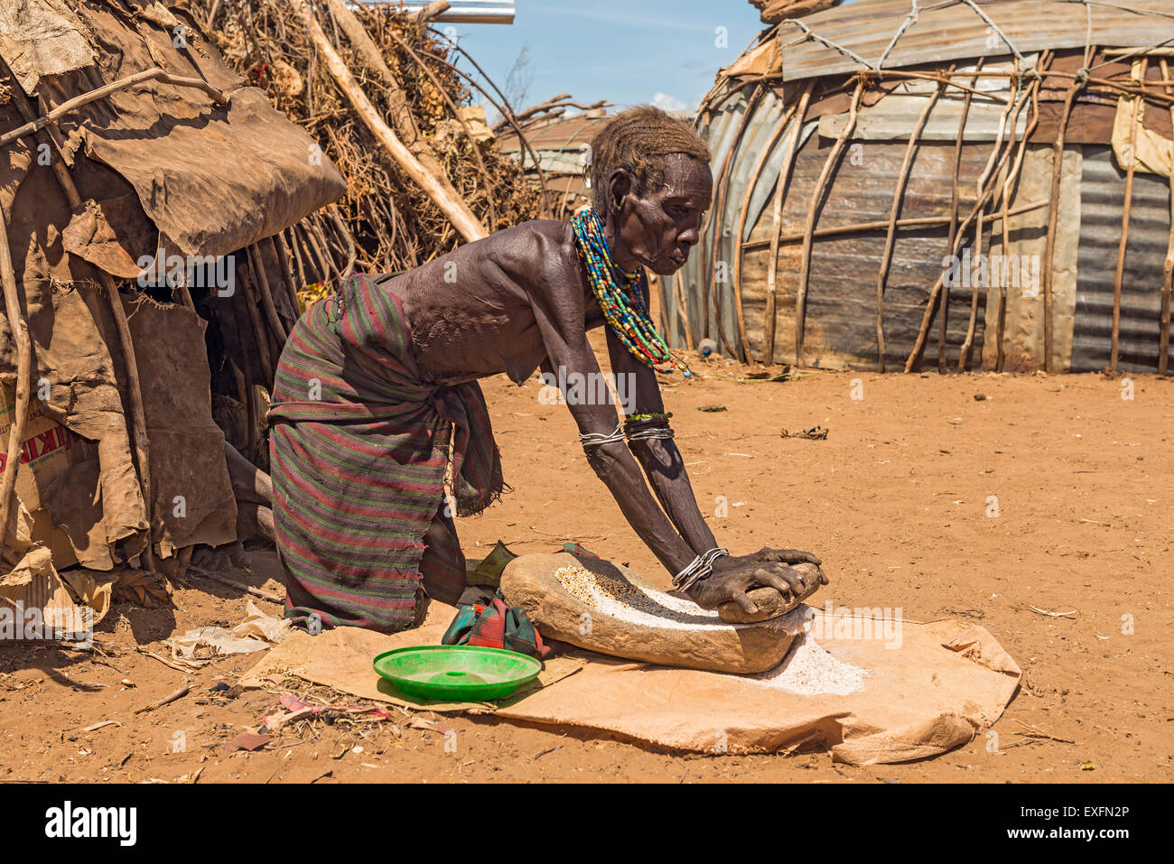 Alte Frau aus dem afrikanischen Stamm Dasanesh fleißig vor ihrer Hütte. Stockfoto