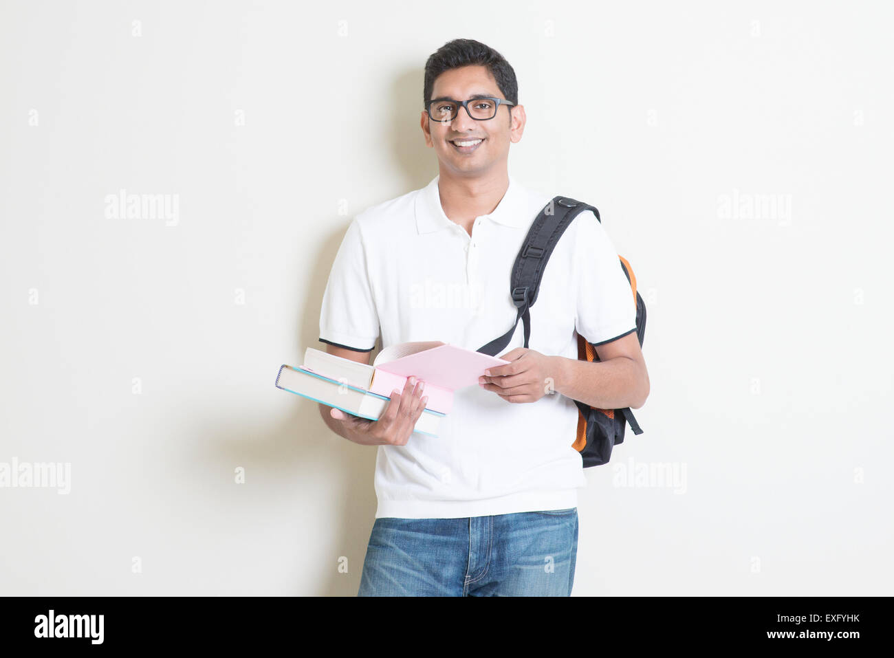 Porträt der Erwachsenen indischen College-Student mit Tasche und Bücher. Asiatischen Mann auf einfarbigen Hintergrund mit Schatten und Kopie. Stockfoto