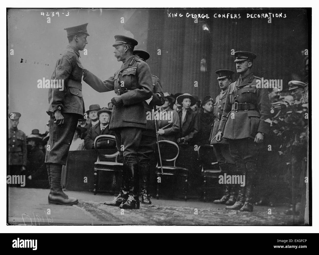 Ein Bild, das König George zeigt, wie er königliche Dekorationen einer Person präsentiert. Die Szene fängt den formellen Moment der Anerkennung ein und unterstreicht den zeremoniellen Charakter der Veranstaltung. Stockfoto