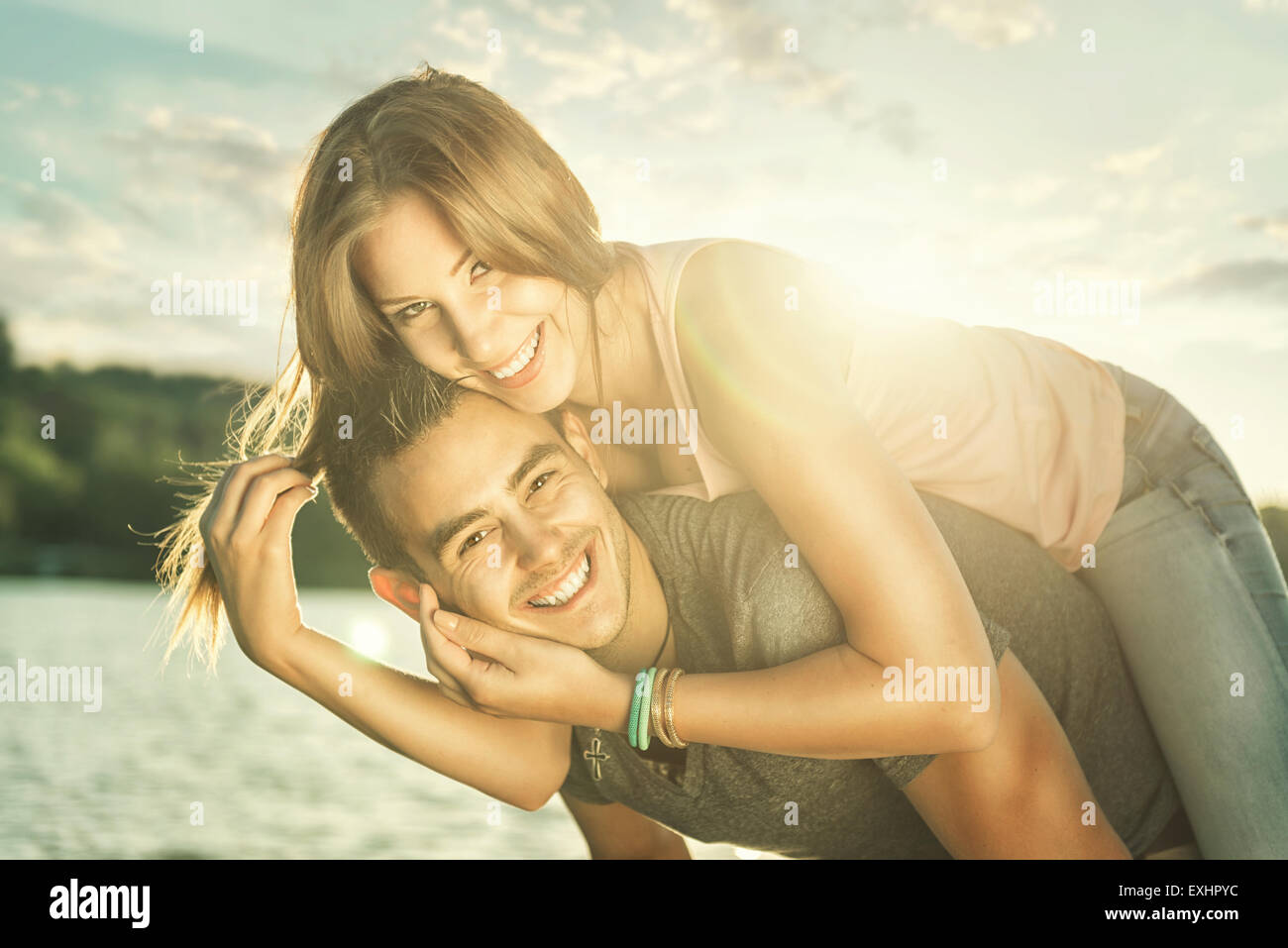 Paar in Liebe umarmen am See, Sonne flare Stockfoto