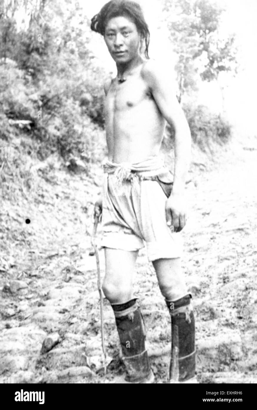 Dieses Foto von 1954 eines tibetischen Maultierfahrers in Kalimpong, Indien, fängt den rauen Lebensstil derjenigen ein, die Güter durch das bergige Gelände transportierten. Der Maultier-Fahrer wird vor der malerischen Kulisse dargestellt und zeigt die traditionellen Transportmethoden, die zu dieser Zeit noch verwendet wurden. Stockfoto