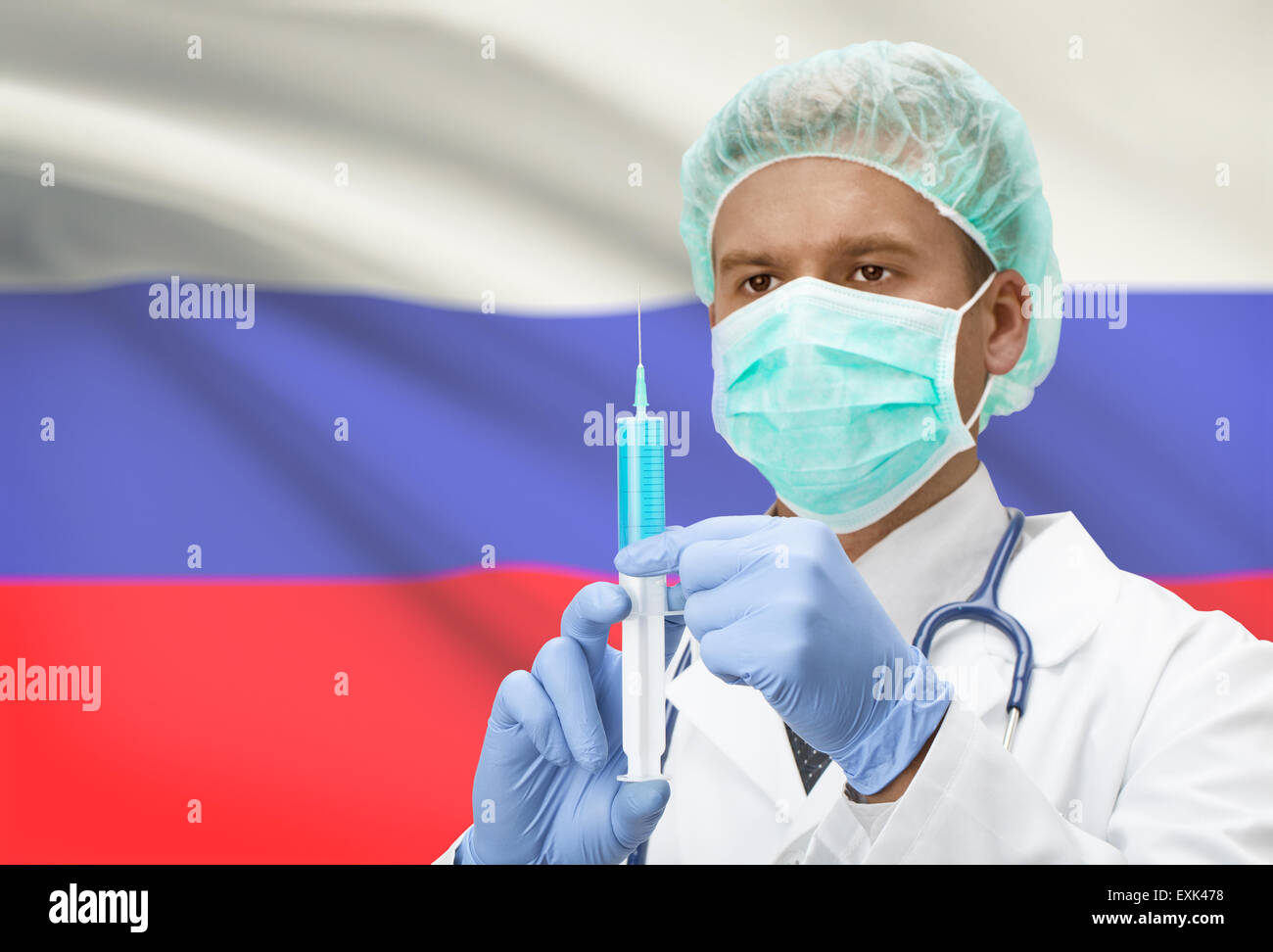 Arzt mit Spritze in Händen und Flagge auf Hintergrund - Russland Stockfoto