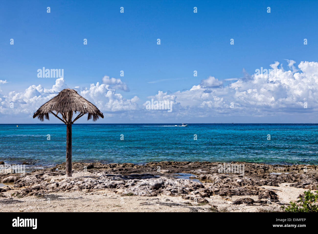 Küste von Cozumel mit Blick auf das Karibische Meer mit einem Strand und einem alten Regenschirm. Stockfoto