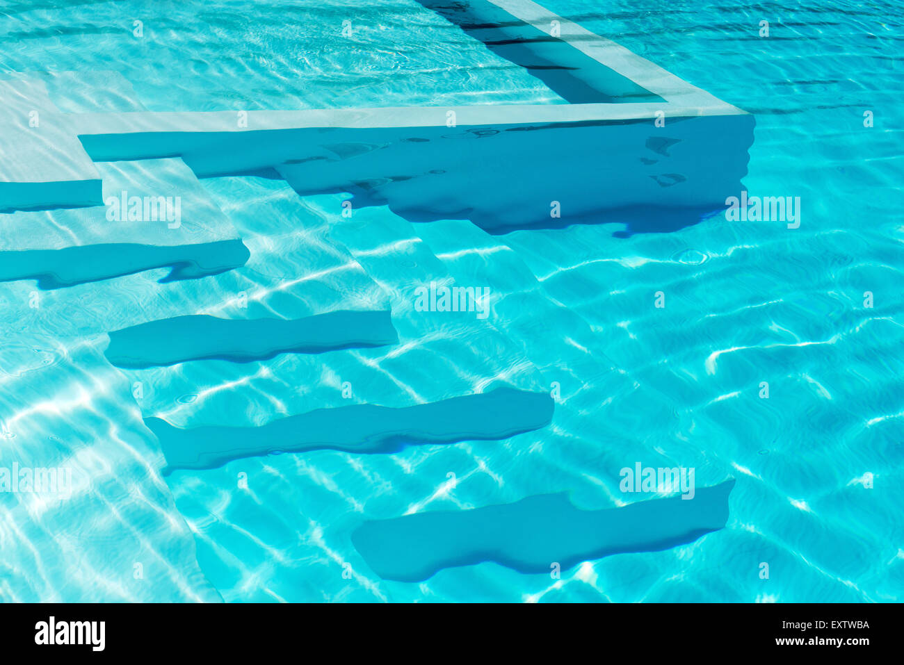 Unterwasser Schritte in einen glitzernden blauen Swimmingpool mit Reflexionen Stockfoto