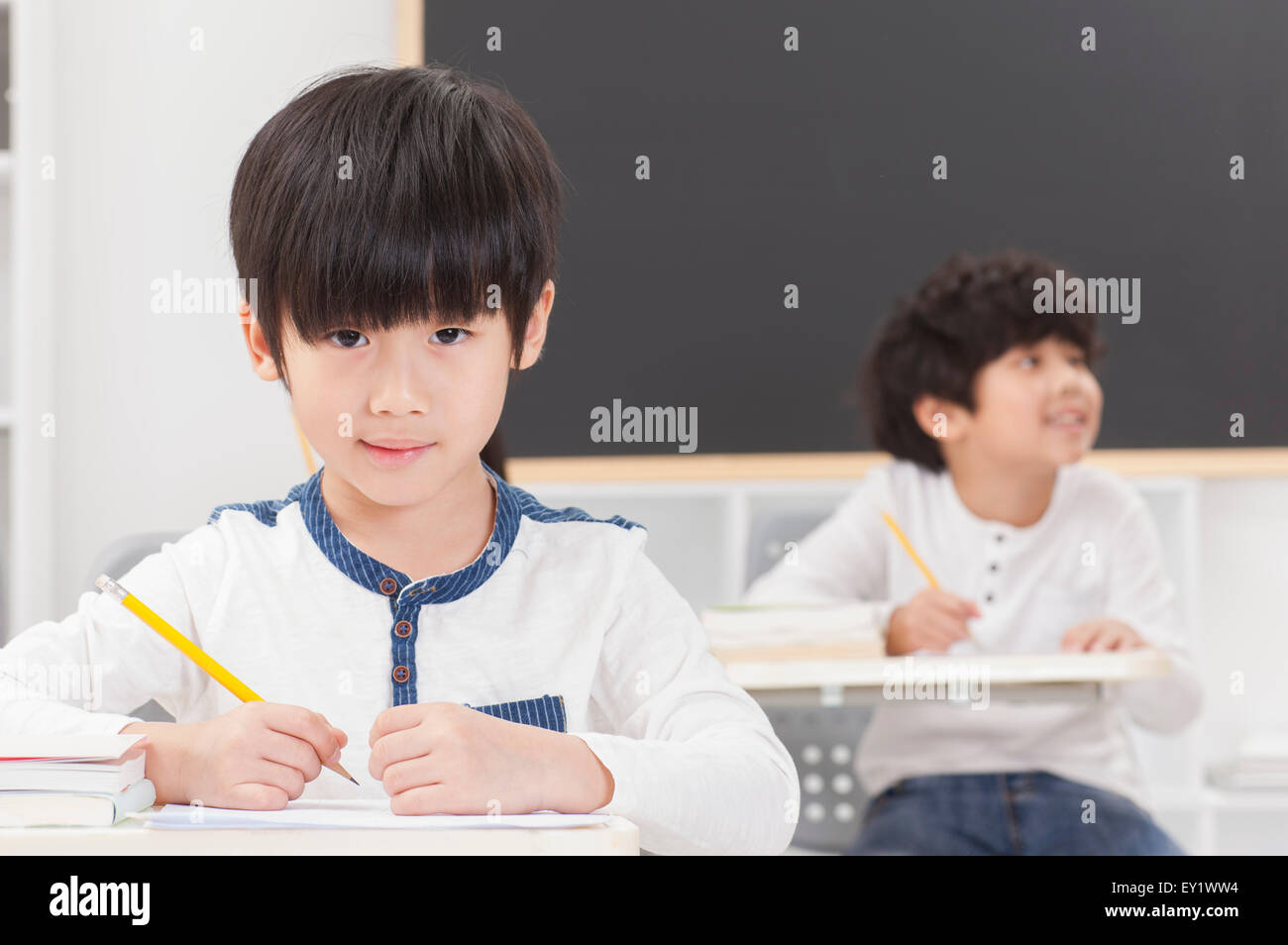 Kinder im Klassenzimmer sitzen und studieren, Stockfoto
