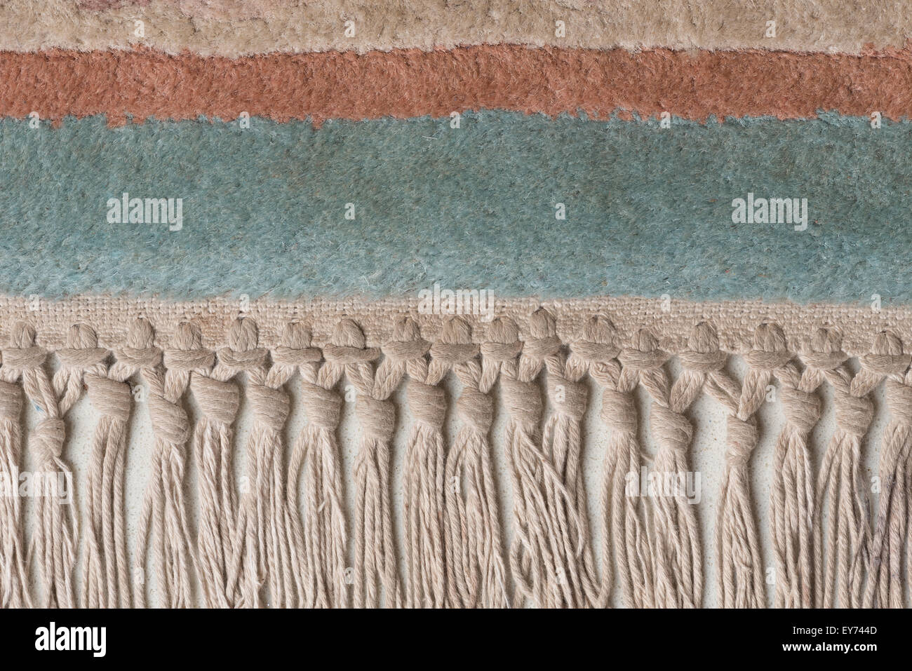 Quasten von hand gewebten Teppich abgenutzt und wellig auf Marmor Stein wie ein Kante Unterschied im Weben, Fringe und den Garaus Grenzen Stockfoto