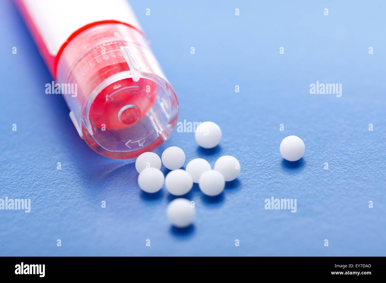 Moderne homöopathische Pillen und Kunststoffbehälter auf blauem Hintergrund Stockfoto