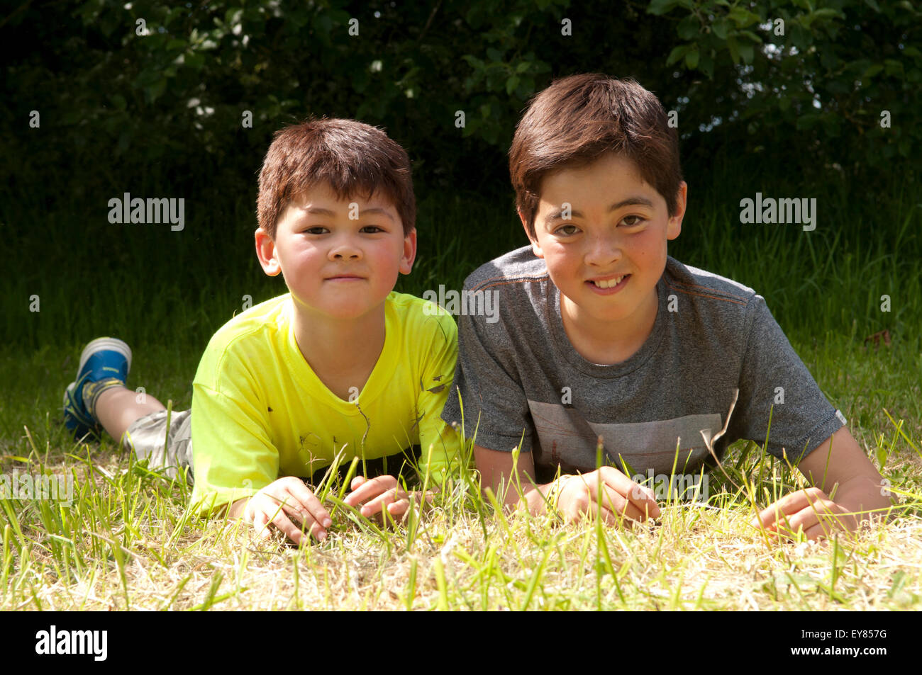 Porträt von zwei Jungs auf dem Rasen lächelnden liegend Stockfoto